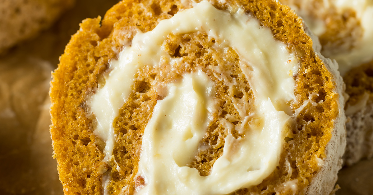 Pumpkin cake wrapped around sweet cream cheese filling in a spiral circle shaped roll